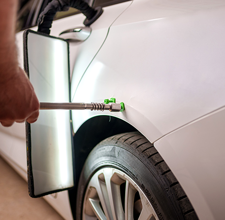 Car dent repair process underway